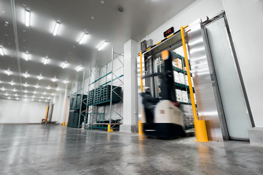 Worker_Stand-on_stacker-truck _used-to-lift_and_move-the-ready-meals-goods-stock-in-cold-room_WEB